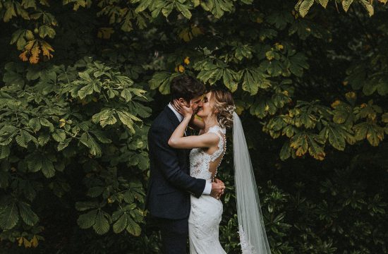 north east wedding photographer andy turner photography bride and groom kissing in front of tree hexham winter gardens