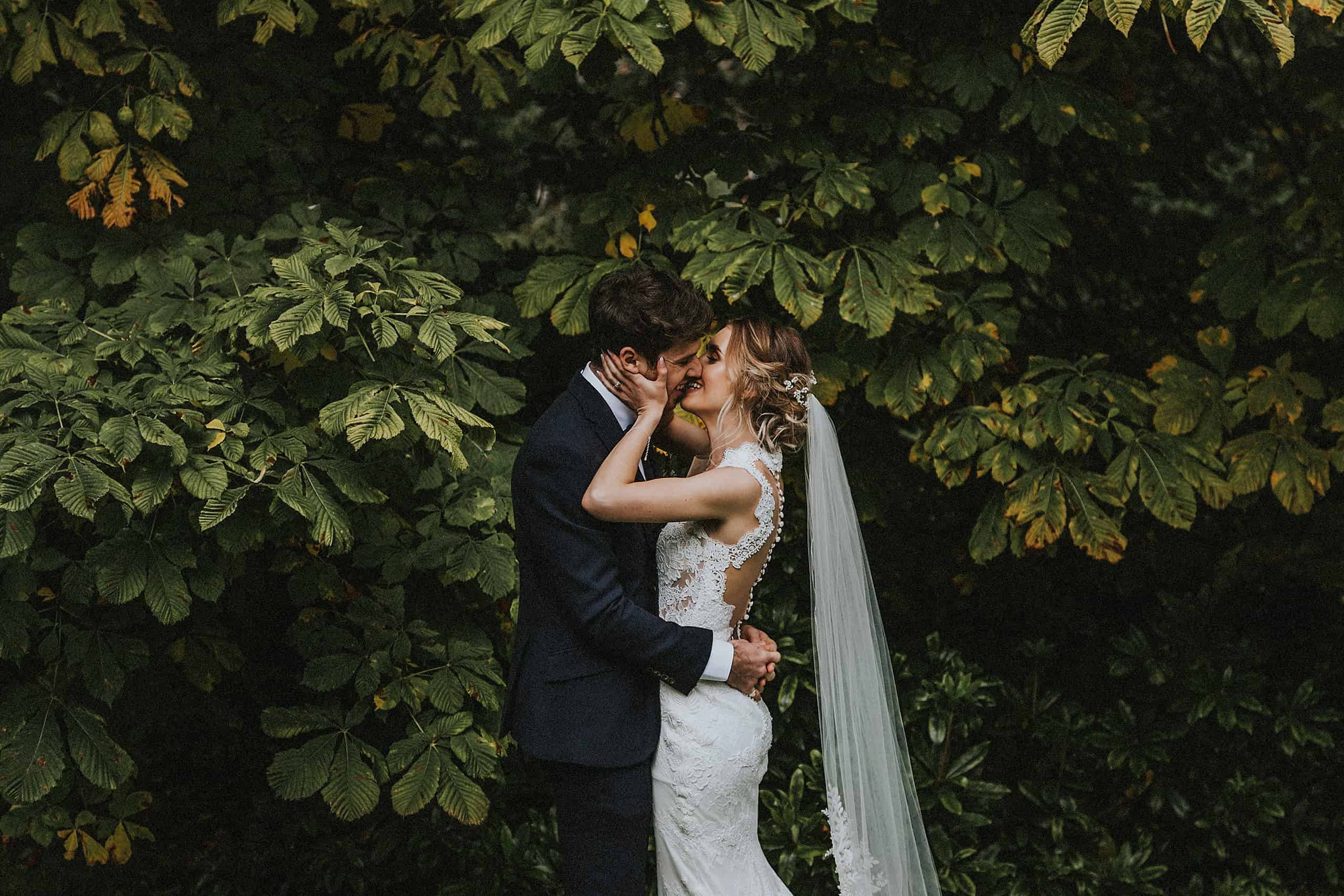 north east wedding photographer andy turner bride and groom kissing under tree