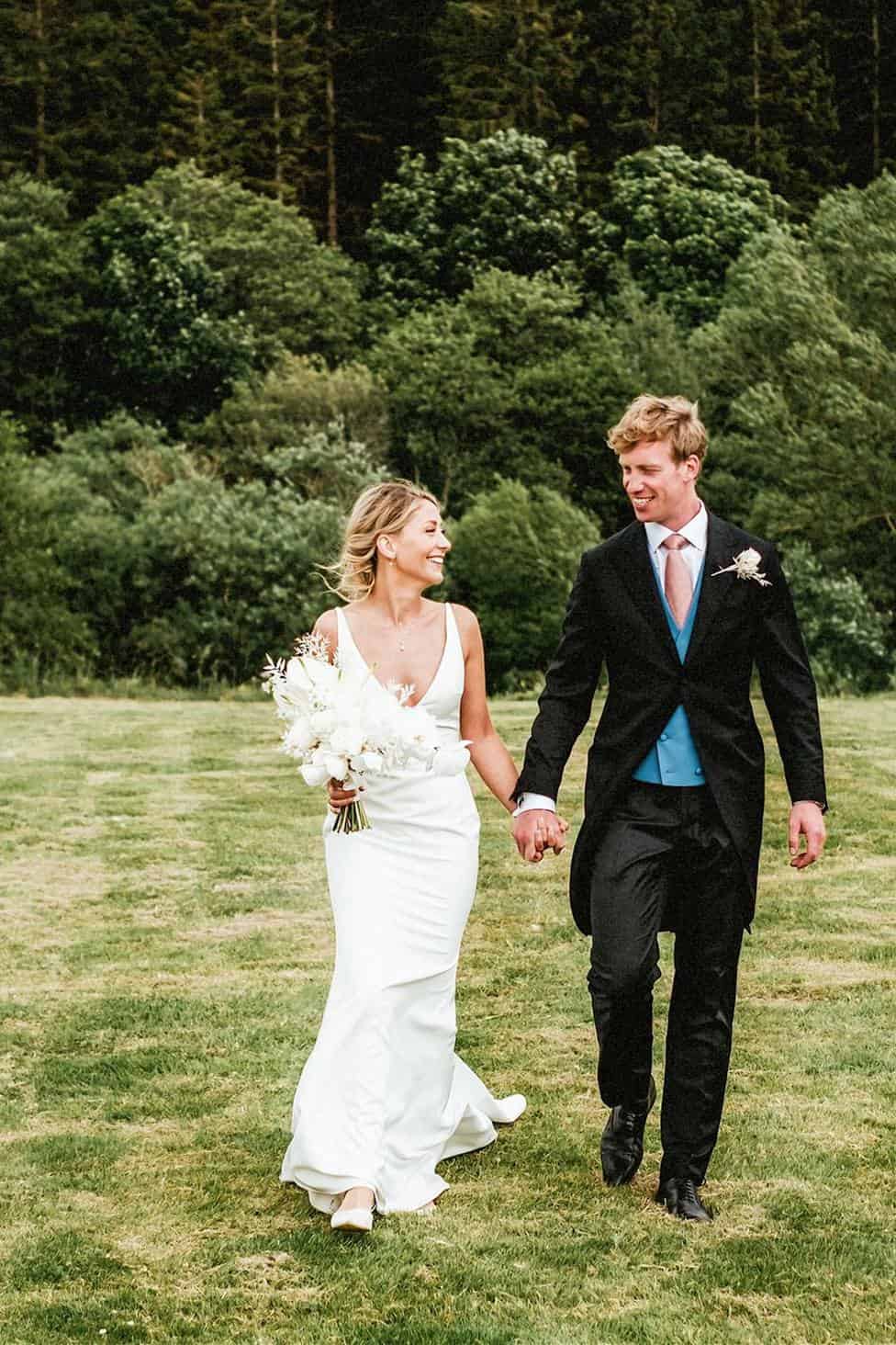 Bride and groom walking hand in hand