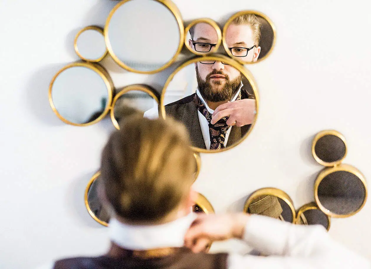 documentray wedding photographer image of groom getting ready in bubble mirror
