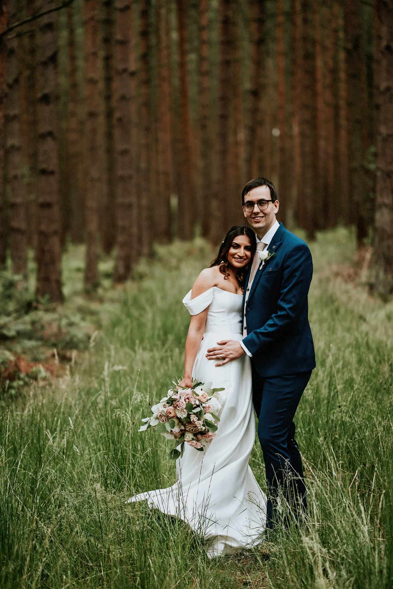 bride and groom in the woods near healey barn