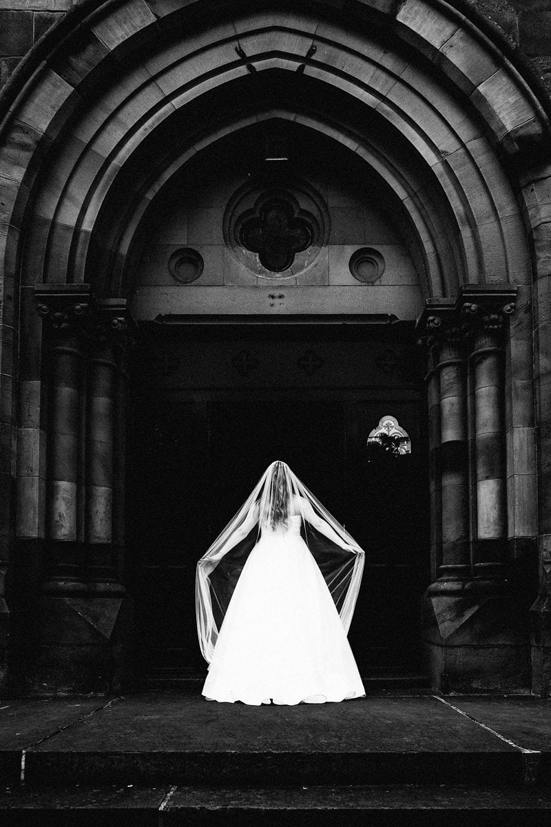 Black and white image of Stephanie walking back into Dalton Old Pump House