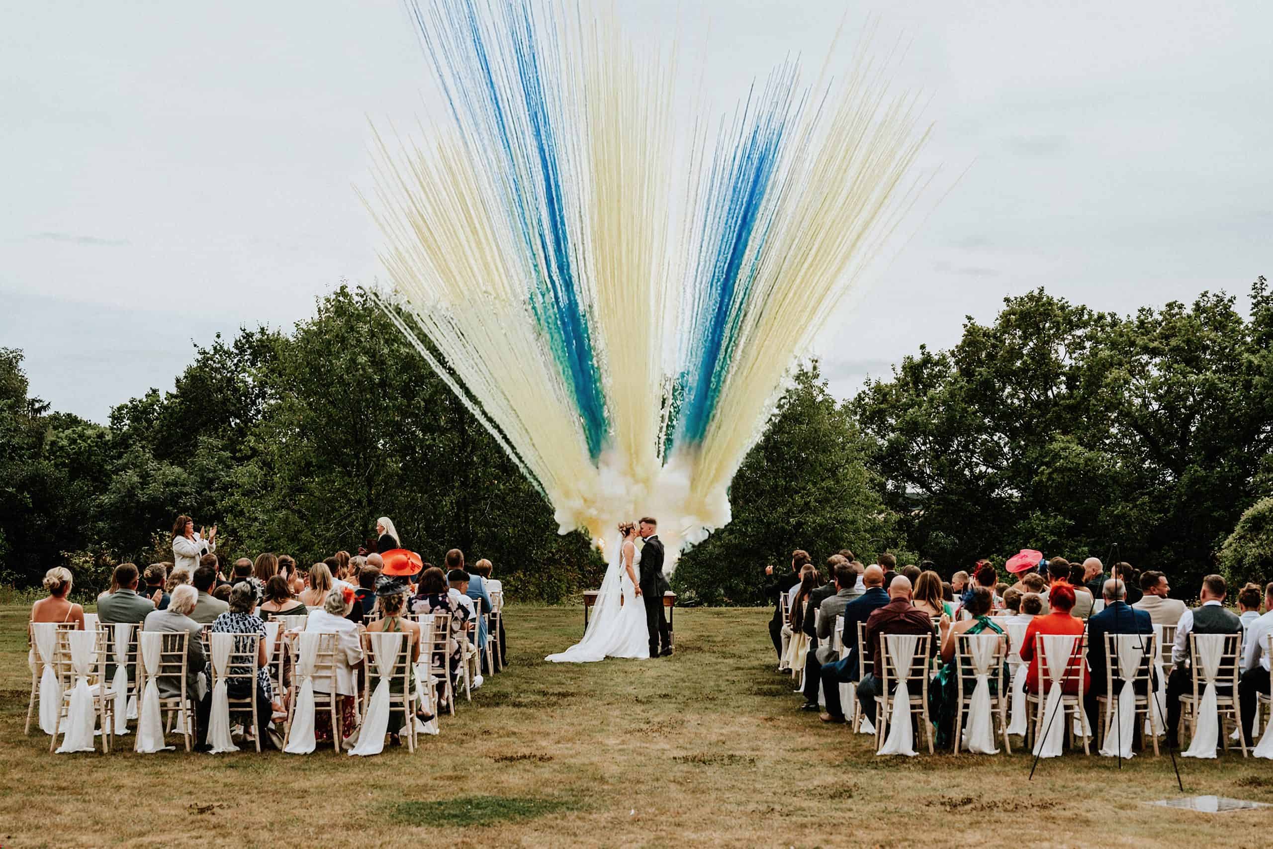 Fireworks going off during an outdoor wedding ceremony at Crathorne Hall